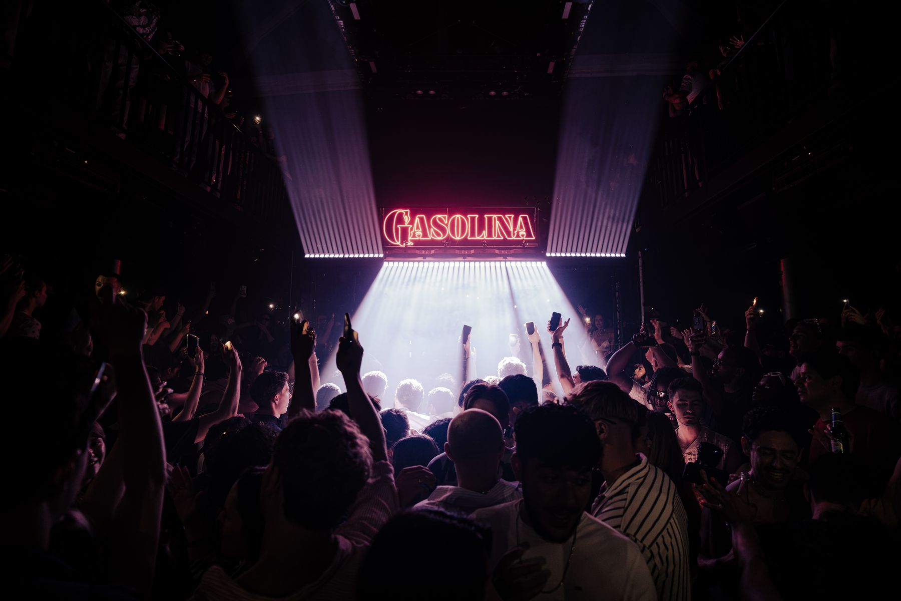 Gasolina neon logo lit above a full dancefloor at C12