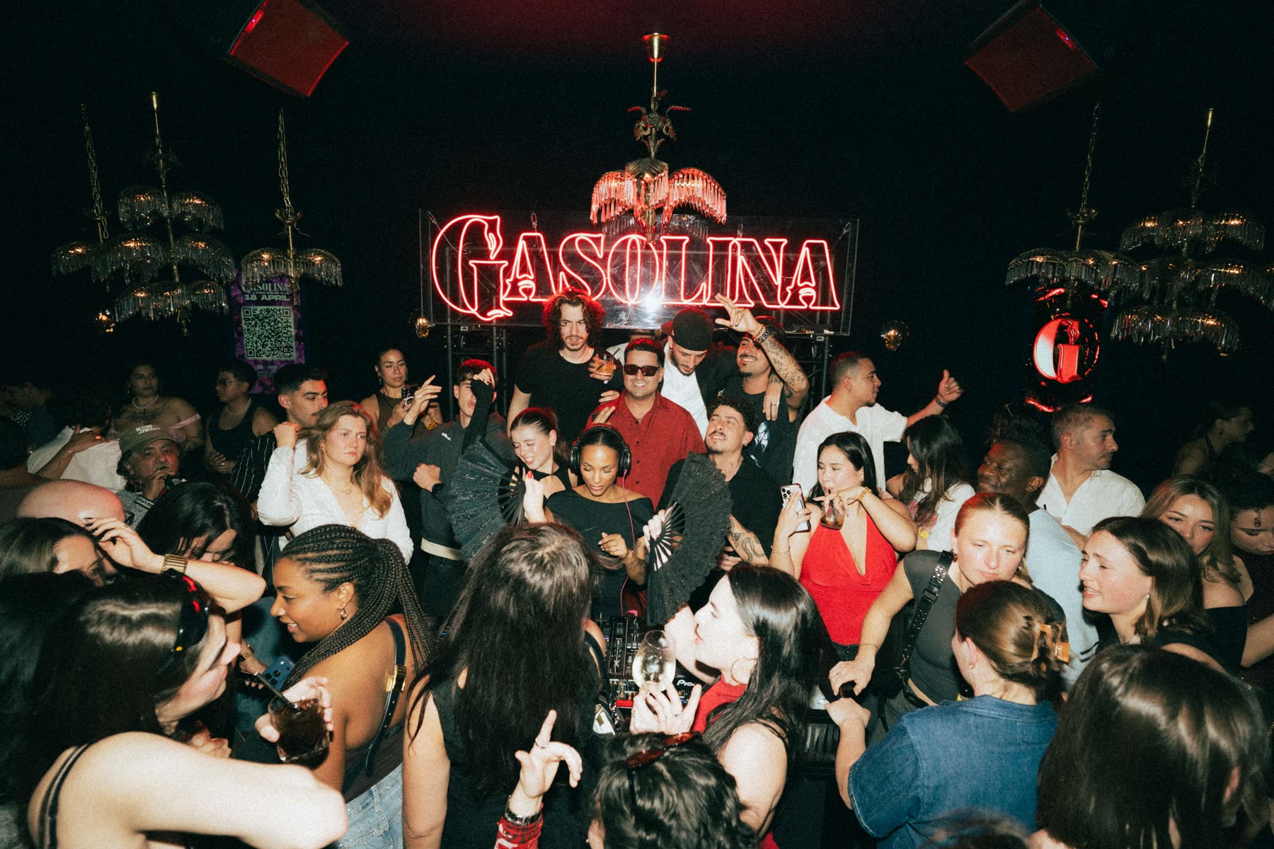 Gasolina neon sign glowing above a packed Social Club dancefloor