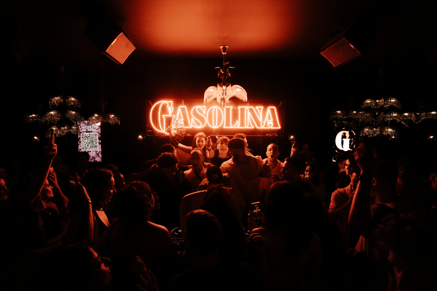Full room facing the glowing Gasolina neon sign